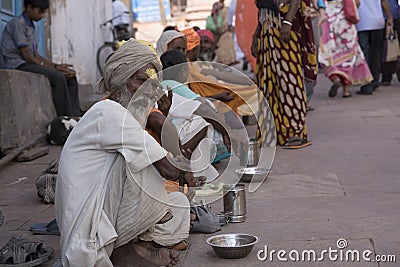 Line of Beggars Sitting Outside a Temple in India Editorial Stock Photo